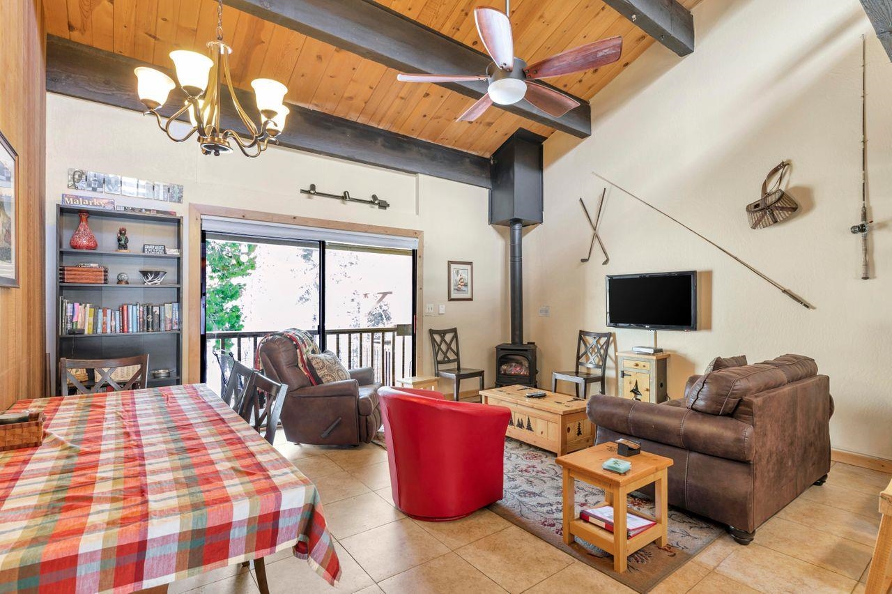 1001 Commonwealth Drive, Unit 156 Kings Beach, CA 96143 - Photo 7 of 21 a living room with furniture fireplace and a flat screen tv