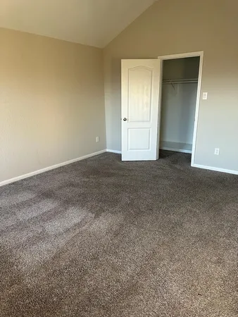 a view of an empty room and closet area