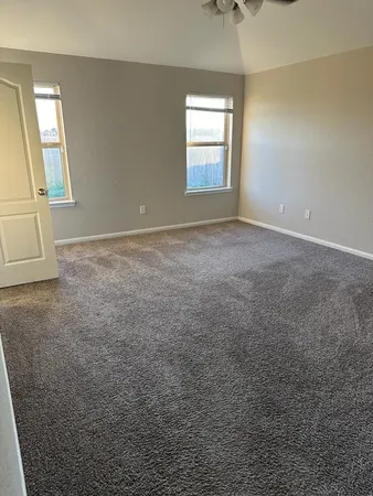 an empty room with windows and entrance