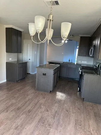 a kitchen with cabinets and stainless steel appliances