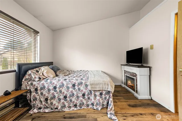 a bedroom with a bed and a flat screen tv