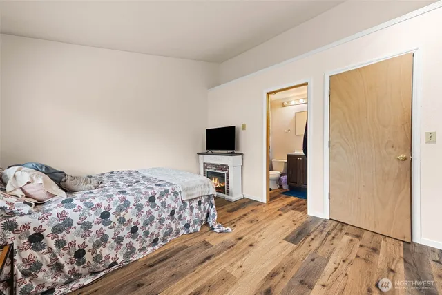 a bedroom with a bed and a flat screen tv