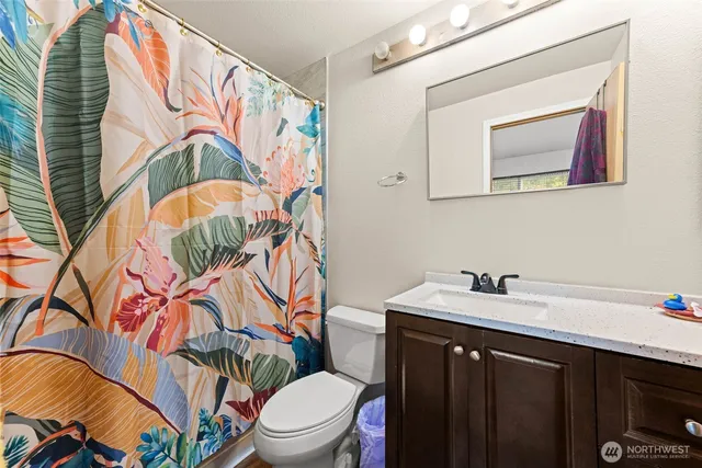 a bathroom with a sink a mirror and a toilet