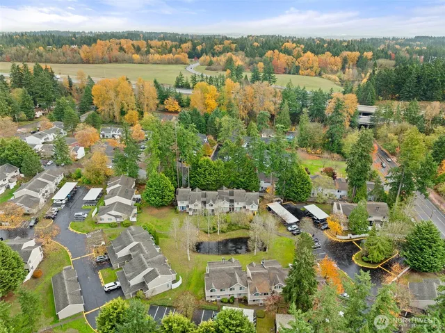 an aerial view of residential building with outdoor space and lake view
