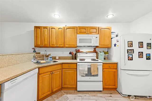 a kitchen with stainless steel appliances granite countertop a sink and cabinets