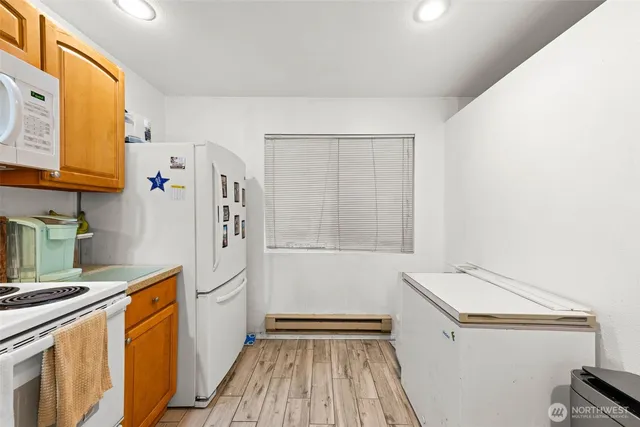 a kitchen with a refrigerator and a stove