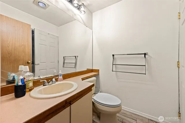 a bathroom with a sink toilet and mirror