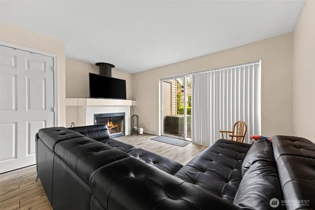 a living room with furniture a fireplace and a flat screen tv