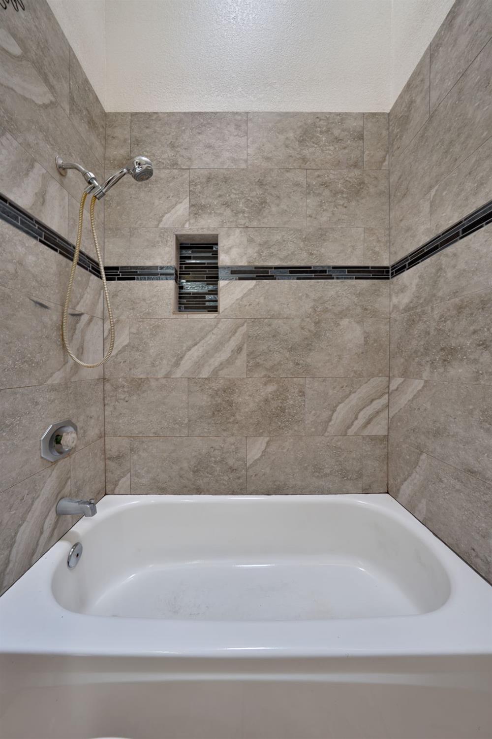 9237 Madison Avenue Orangevale, CA 95662 - Photo 20 of 40 a bathroom with a bathtub and a shower