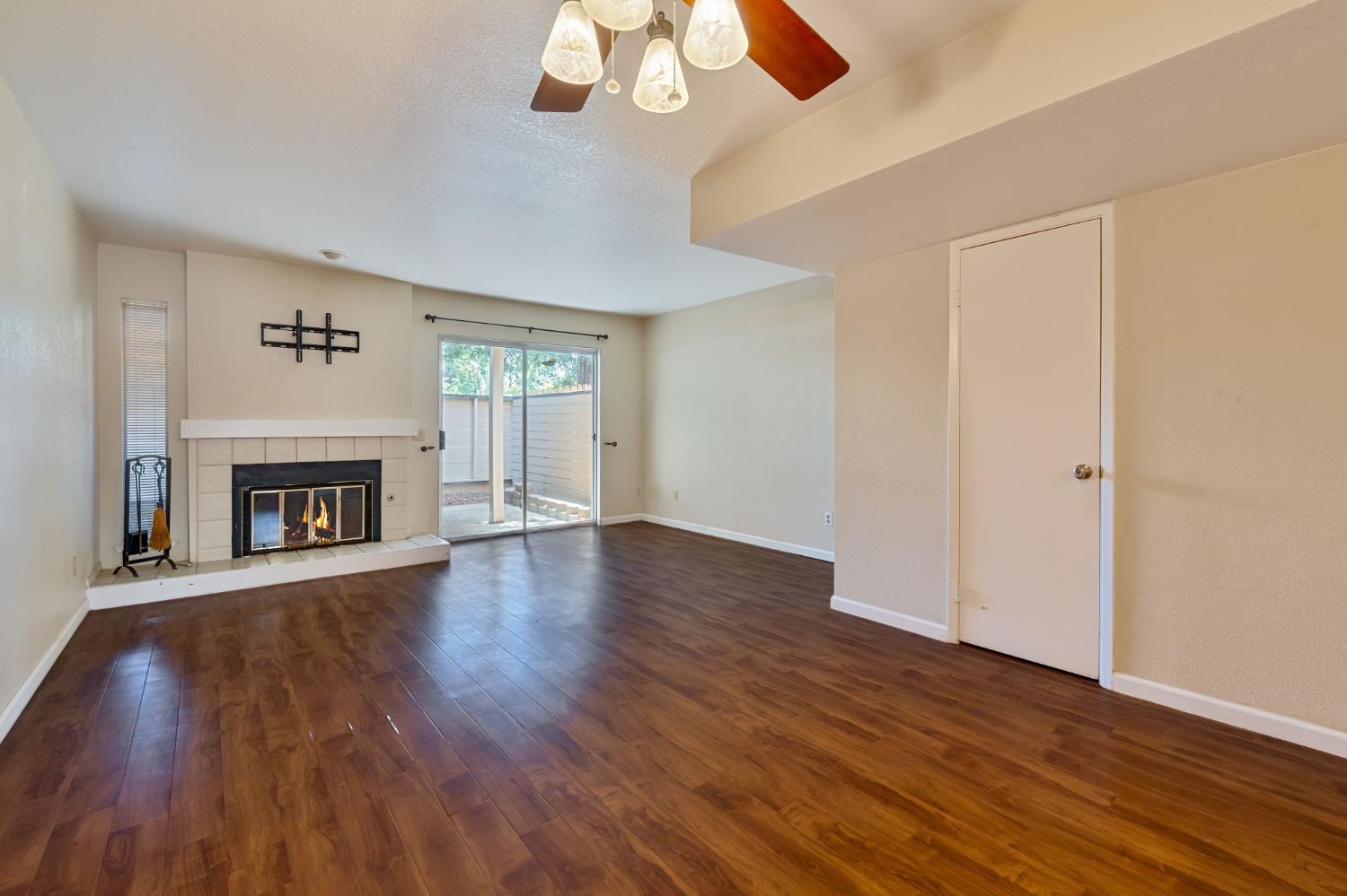9237 Madison Avenue Orangevale, CA 95662 - Photo 6 of 40 a view of an empty room with wooden floor and a window