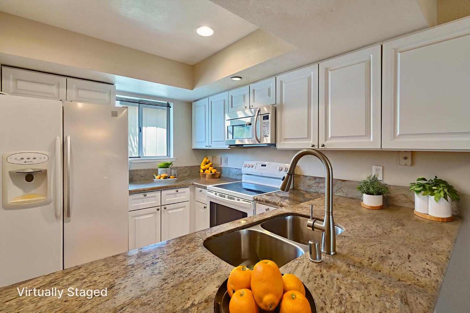 9237 Madison Avenue Orangevale, CA 95662 - Photo 9 of 40 a kitchen with stainless steel appliances granite countertop a sink refrigerator and cabinets