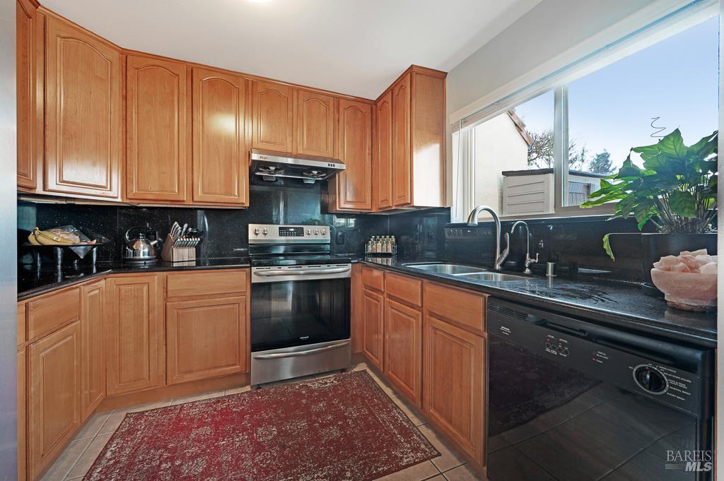 1749 Las Raposas Court Santa Rosa, CA 95409 - Photo 13 of 31 a kitchen with stainless steel appliances granite countertop a sink stove and refrigerator