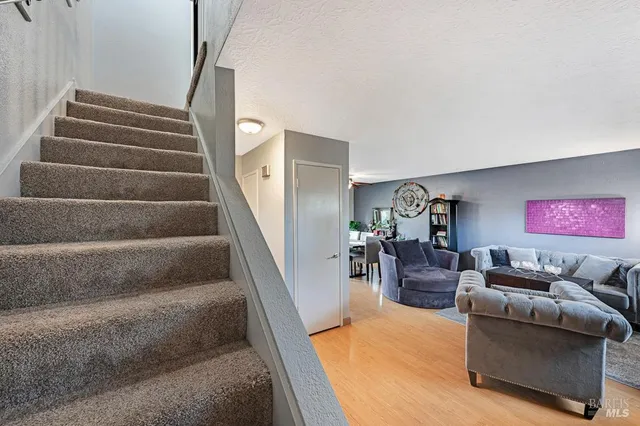 a living room with furniture and stairs