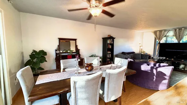 a living room with furniture a flat screen tv and a chandelier