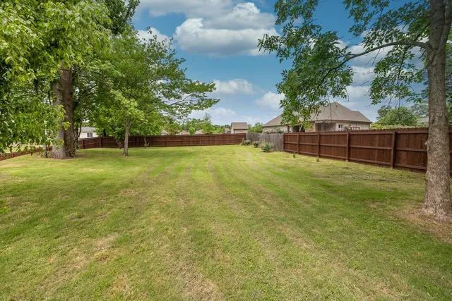a swimming pool with some trees in the background