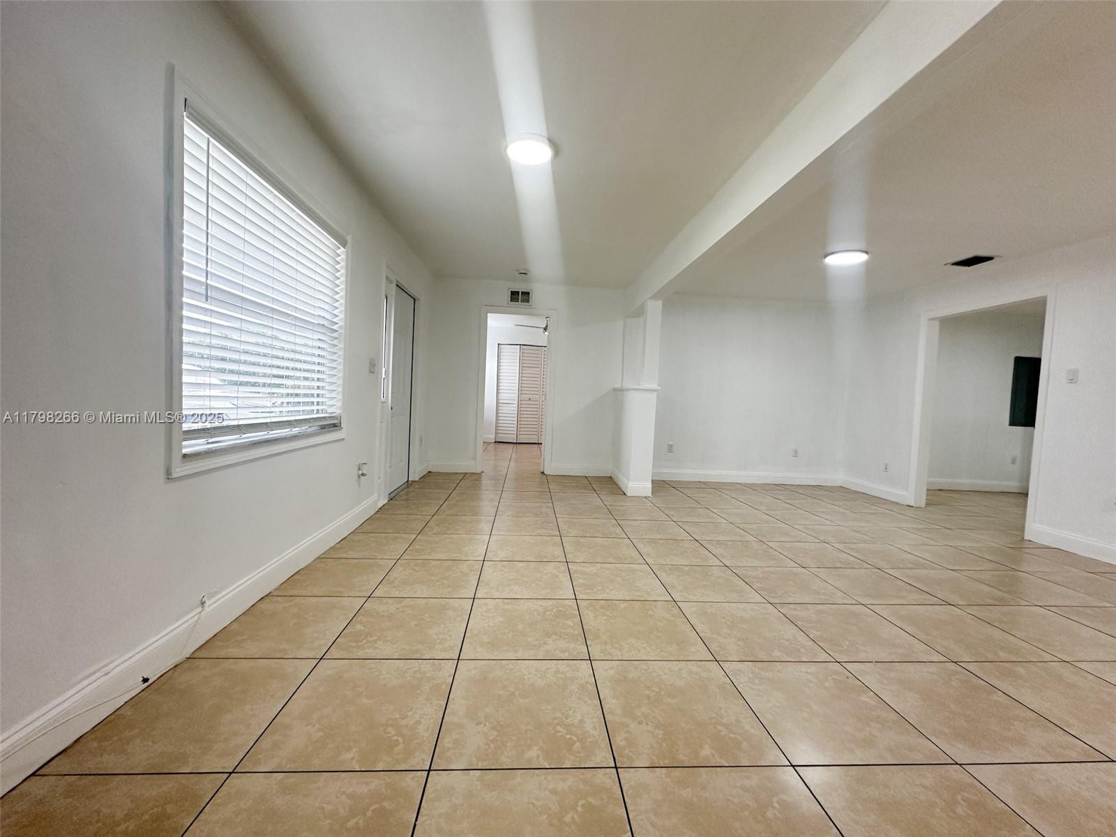 2811 Northwest 88th Street, Unit 1 Miami, FL 33147 - Photo 3 of 10 a view of an empty room with a window