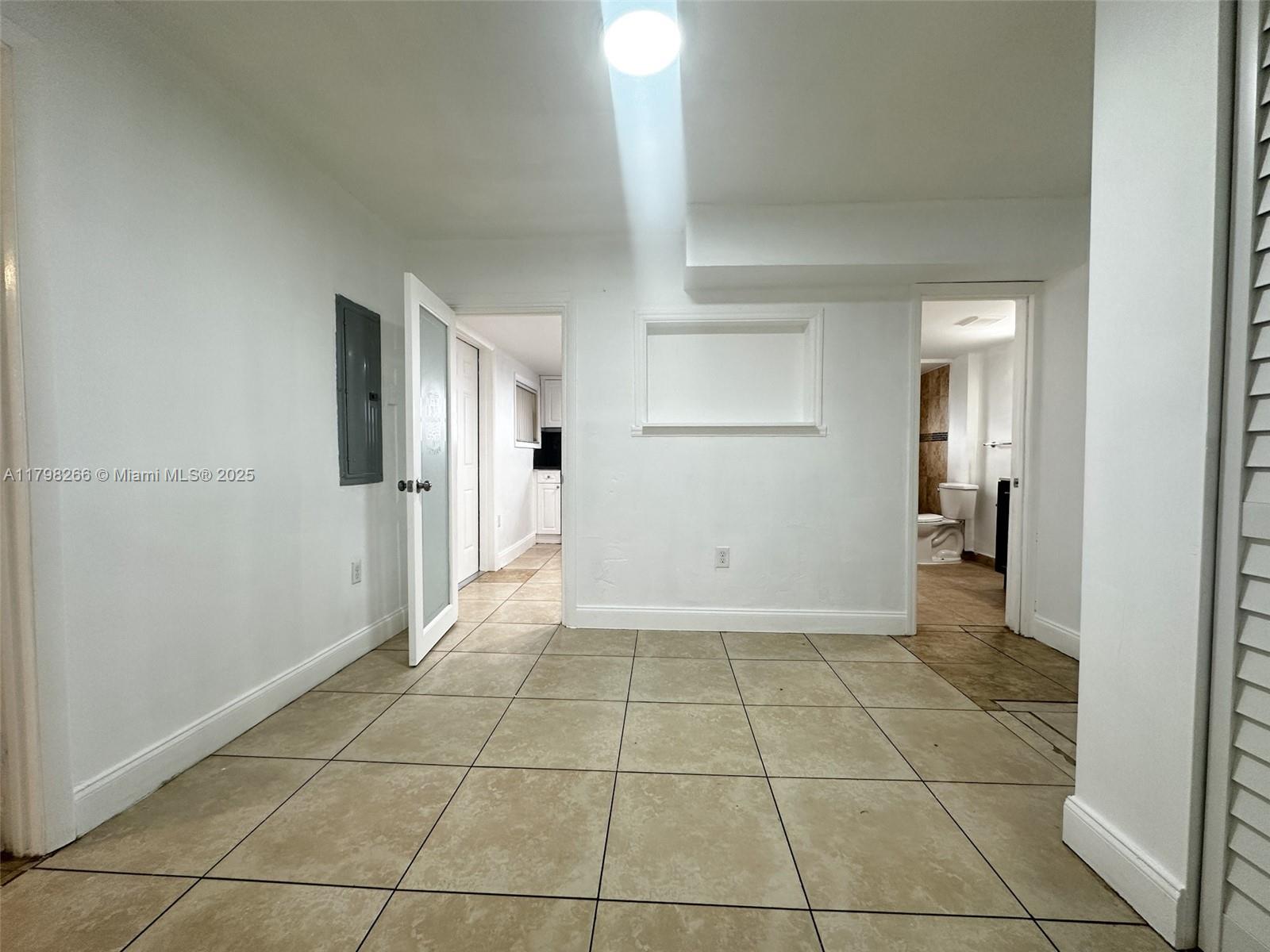 2811 Northwest 88th Street, Unit 1 Miami, FL 33147 - Photo 4 of 10 a view of a hallway with a bathroom