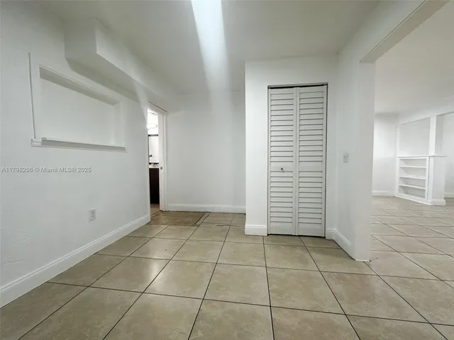 a kitchen with a refrigerator and a stove