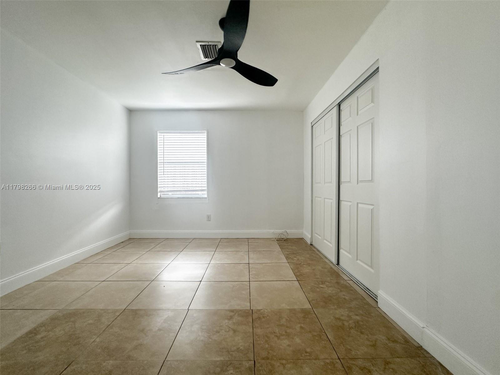 2811 Northwest 88th Street, Unit 1 Miami, FL 33147 - Photo 9 of 10 a view of an empty room and window