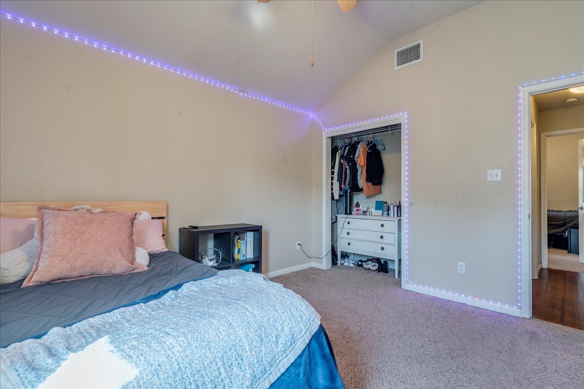 18424 Dry Brook Loop Pflugerville, TX 78660 - Photo 20 of 25 Carpeted bedroom with a closet and lofted ceiling