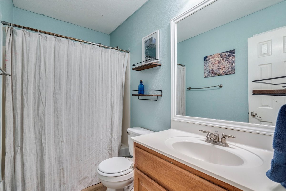 18424 Dry Brook Loop Pflugerville, TX 78660 - Photo 23 of 25 Bathroom featuring vanity and shower / bathtub combination with curtain