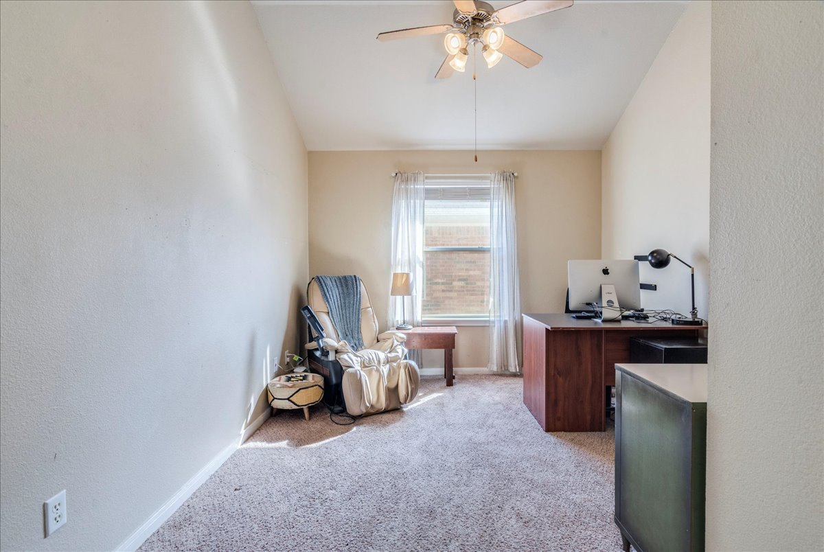 18424 Dry Brook Loop Pflugerville, TX 78660 - Photo 24 of 25 Carpeted home office with a ceiling fan, vaulted ceiling, and a textured wall