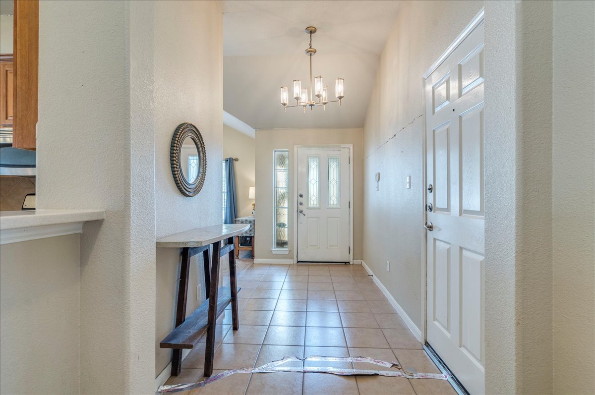 18424 Dry Brook Loop Pflugerville, TX 78660 - Photo 7 of 25 Entrance foyer with light tile patterned floors, hanging lights, and vaulted ceiling