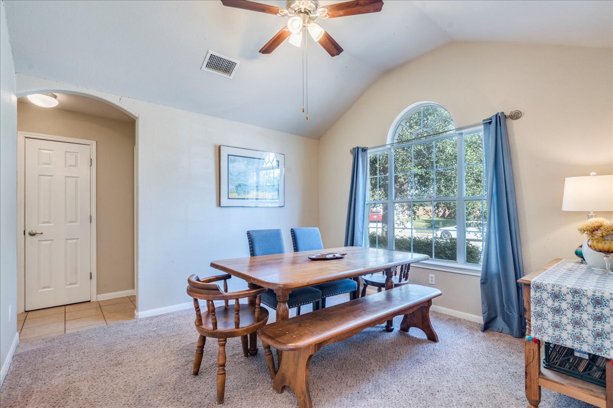 18424 Dry Brook Loop Pflugerville, TX 78660 - Photo 8 of 25 Dining room featuring light carpet, a ceiling fan, and arched walkways