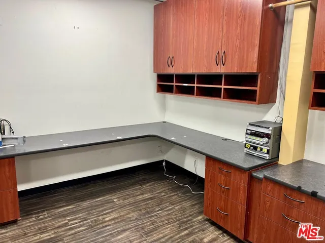 a kitchen with wooden floor and a sink