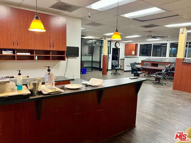 a kitchen with sink and view of living room