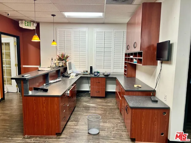 a kitchen with stainless steel appliances granite countertop a sink a stove and a wooden cabinets