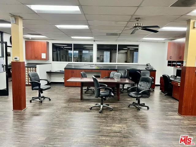 a living room filled with furniture and a wooden floor