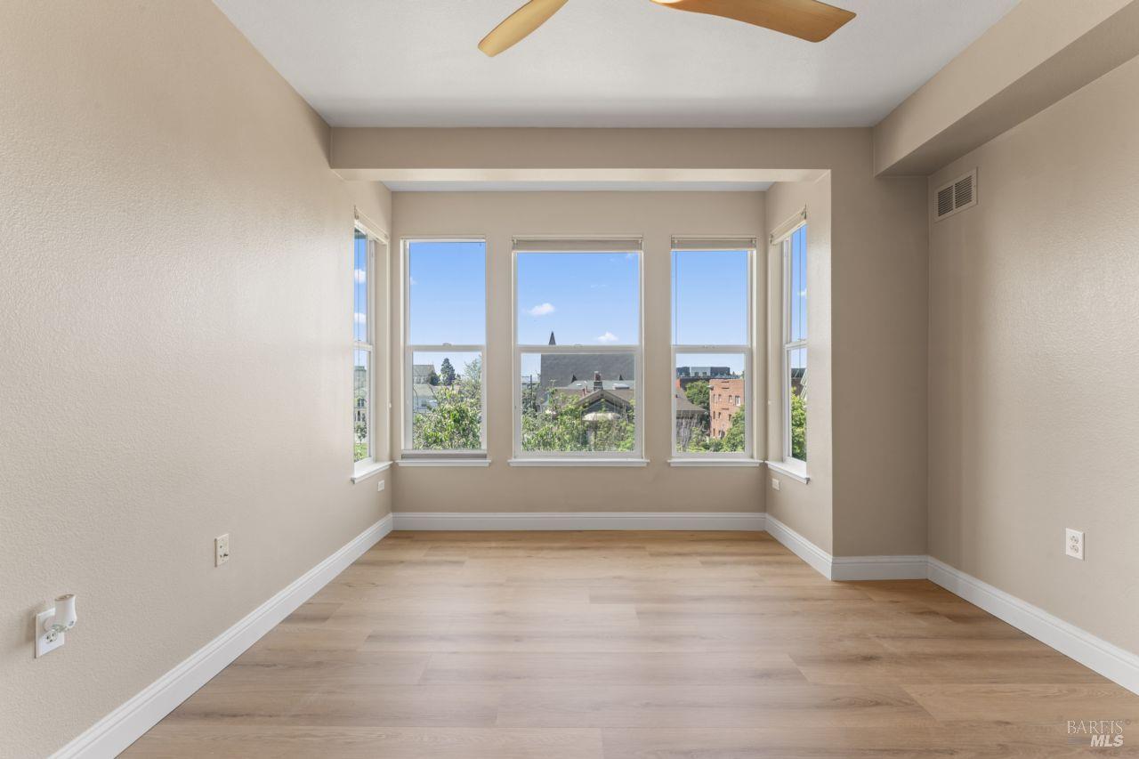 655 12th Street, Unit 311 Oakland, CA 94607 - Photo 15 of 29 wooden floor in an empty room with a window