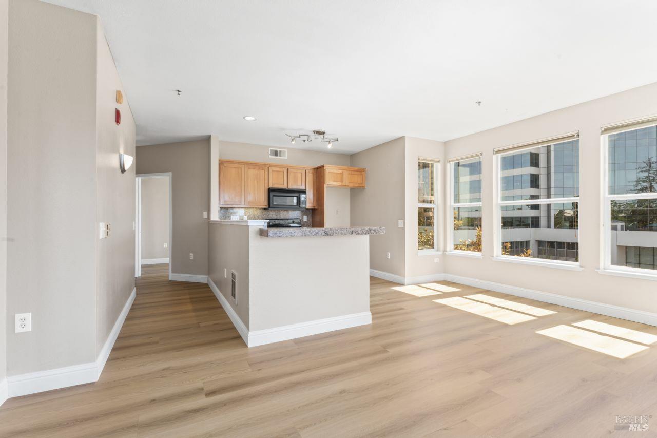 655 12th Street, Unit 311 Oakland, CA 94607 - Photo 23 of 29 a view of kitchen with kitchen island wooden floor and refrigerator