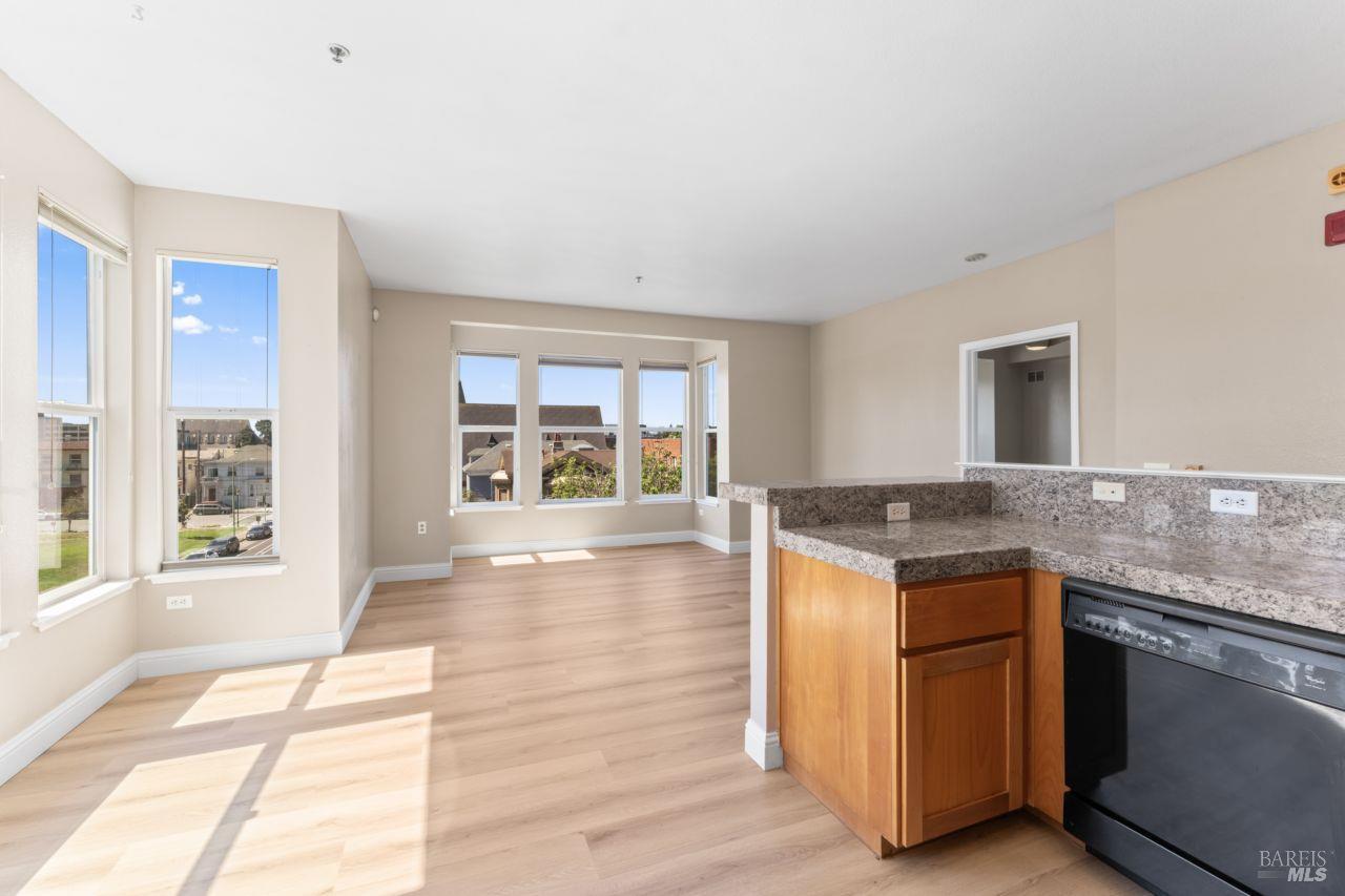655 12th Street, Unit 311 Oakland, CA 94607 - Photo 10 of 29 a kitchen with a stove a sink and a window