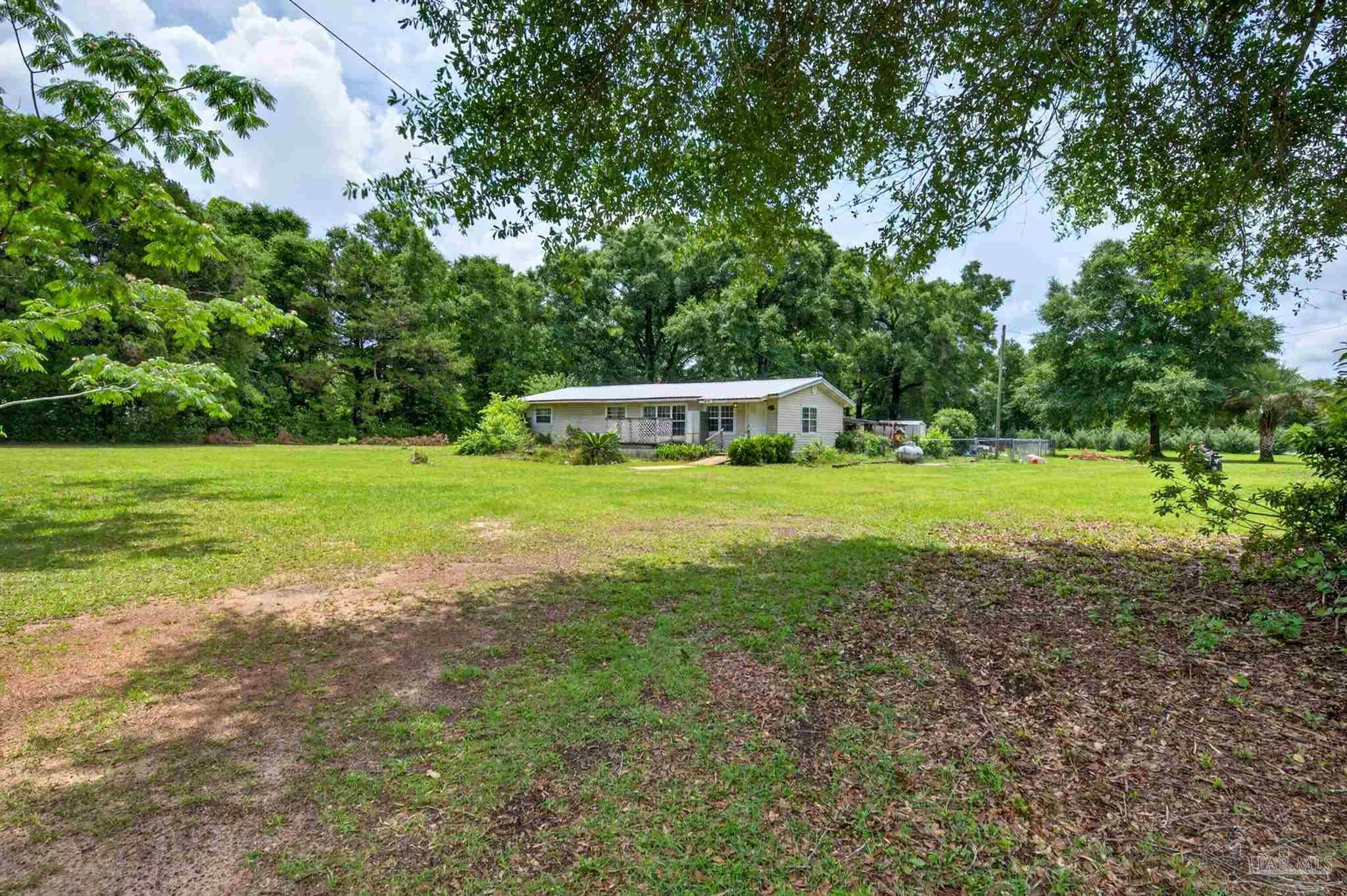 6253 Allentown Road Milton, FL 32570 - Photo 30 of 31 a view of a house with a yard and sitting area