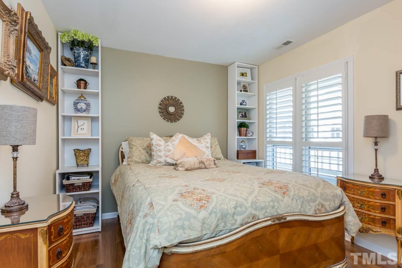 1000 Brighthurst Drive, Unit 301 Raleigh, NC 27605 - Photo 13 of 24 a bedroom with a bed and a window
