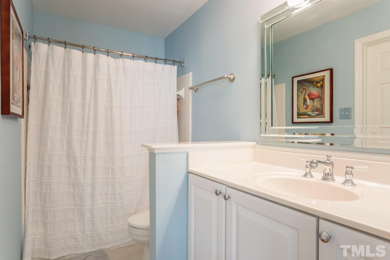 1000 Brighthurst Drive, Unit 301 Raleigh, NC 27605 - Photo 16 of 24 a bathroom with a sink and a mirror
