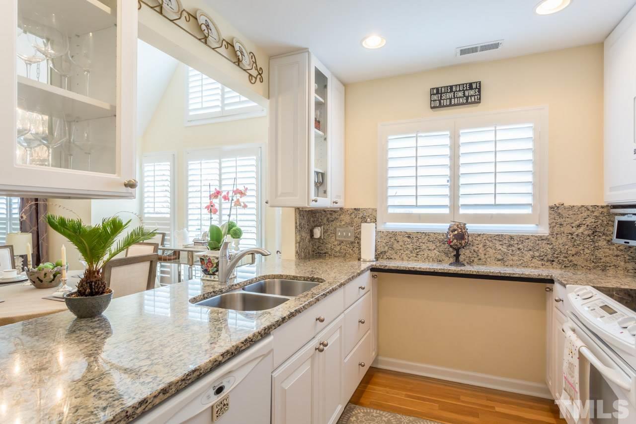 1000 Brighthurst Drive, Unit 301 Raleigh, NC 27605 - Photo 4 of 24 a kitchen with stainless steel appliances granite countertop a sink a counter space and windows