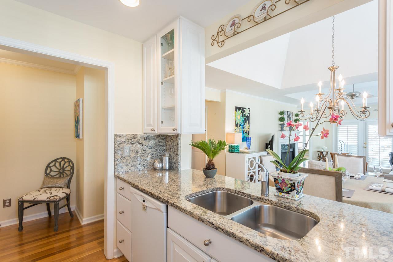 1000 Brighthurst Drive, Unit 301 Raleigh, NC 27605 - Photo 6 of 24 a bathroom with sink and mirror