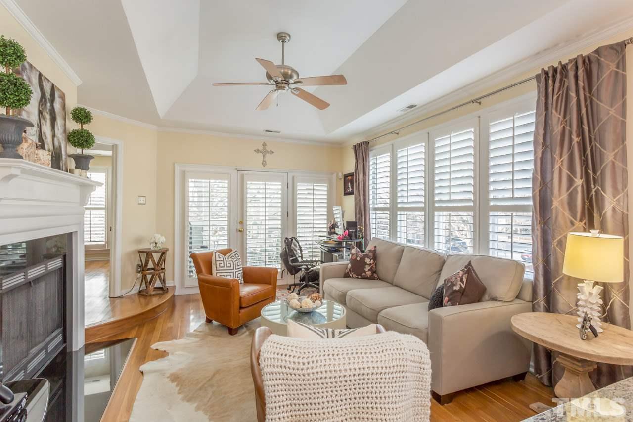 1000 Brighthurst Drive, Unit 301 Raleigh, NC 27605 - Photo 10 of 24 a living room with furniture a fireplace and a large window