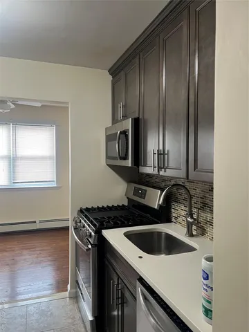 a kitchen with kitchen island granite countertop a refrigerator stove and cabinets