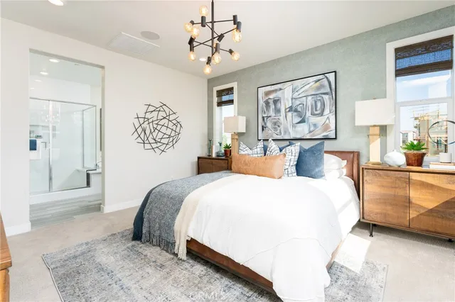 a spacious bedroom with a bed and lamp