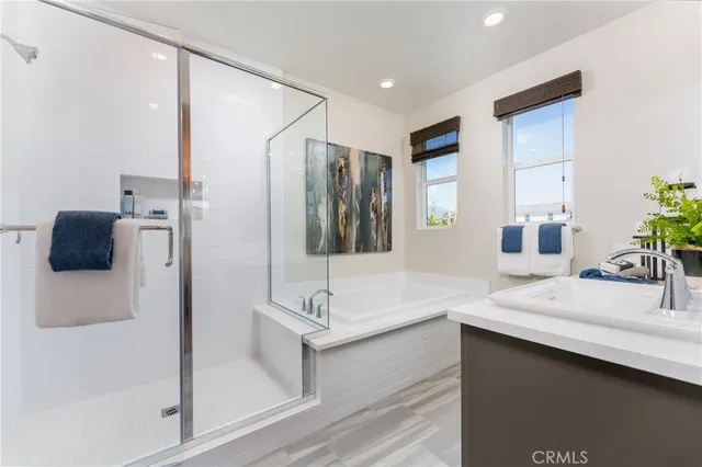 a bathroom with a double vanity sink mirror and shower