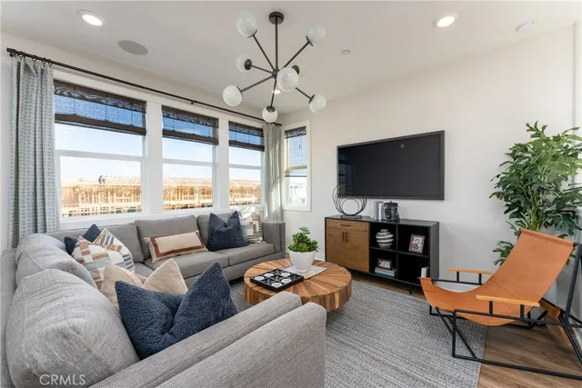 a living room with furniture a large window and a flat screen tv