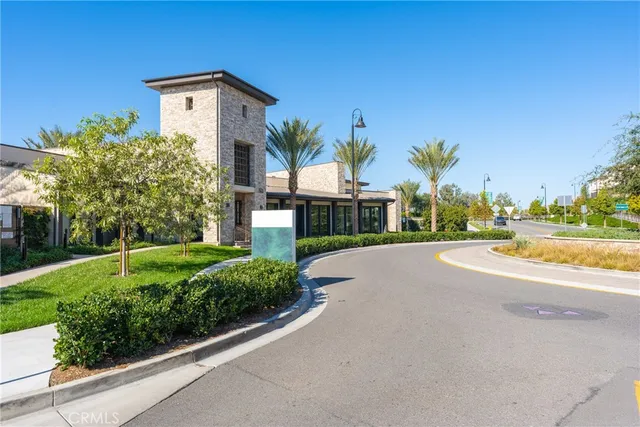 a front view of a house with a yard and fountain