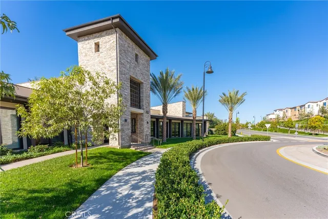 a view of a street with a building and a big yard
