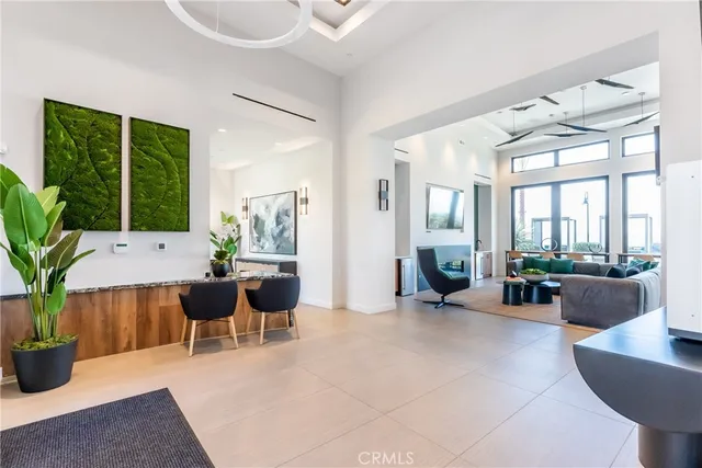 a living room with furniture potted plant and a large window