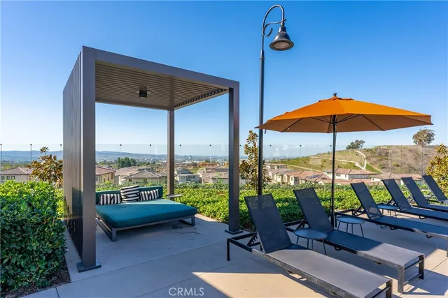 a view of a patio with a table chairs and a backyard