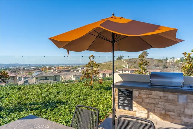 a view of a yard tables and chairs under an umbrella